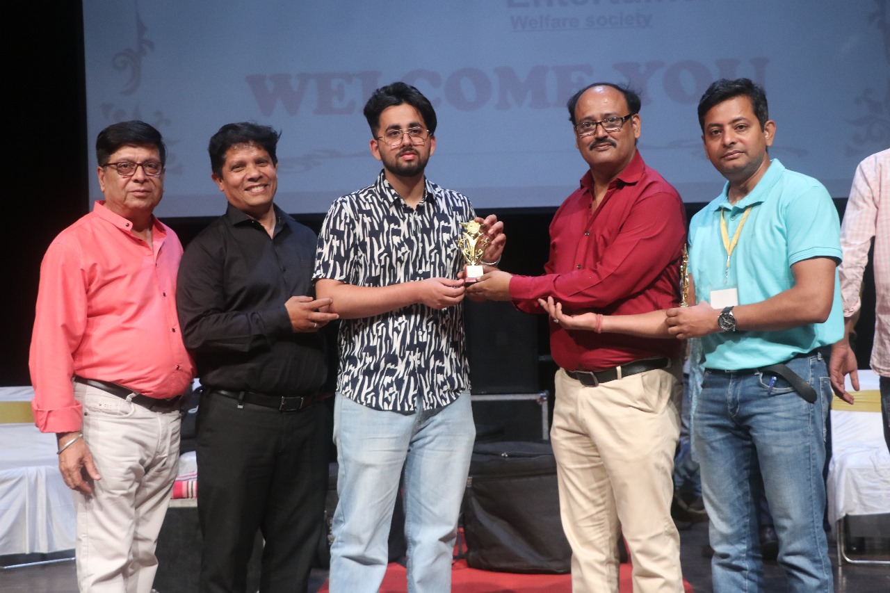 Ansh Verma (B.Com. III) — receiving recognition for musical achievement.